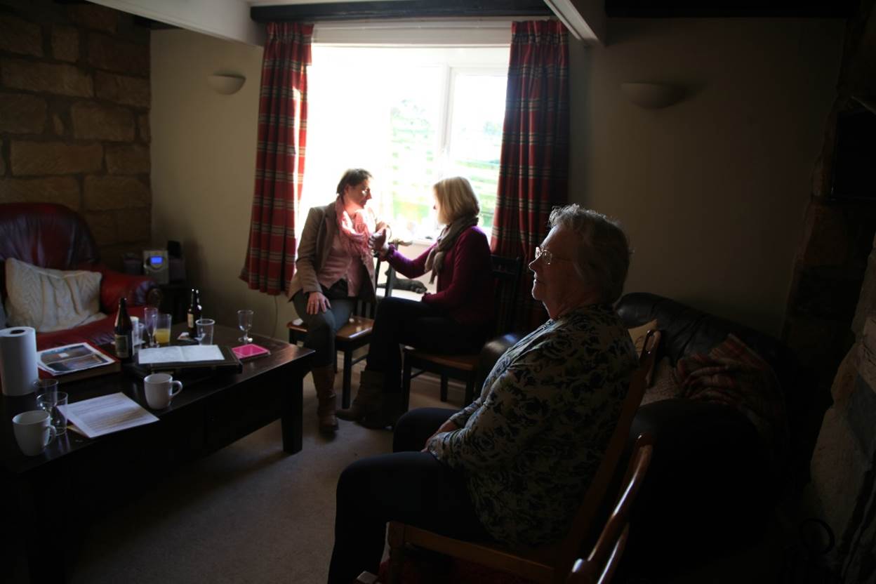 A group of women sitting in a room
Description automatically generated